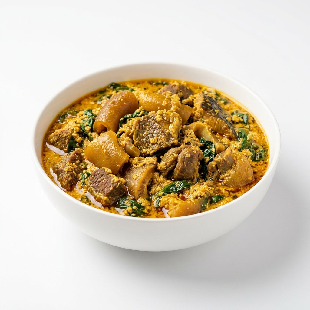 A white ceramic bowl filled with a rich, yellow-orange stewed meat and vegetable dish, set against a clean white background.