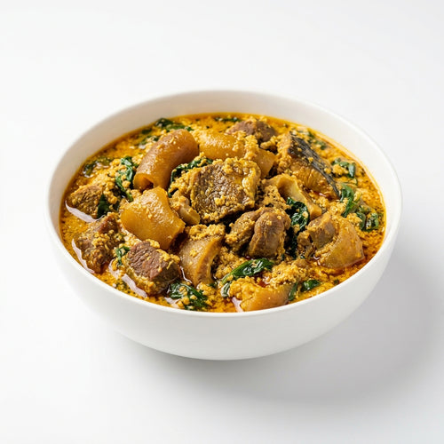 A white ceramic bowl filled with a rich, yellow-orange stewed meat and vegetable dish, set against a clean white background.