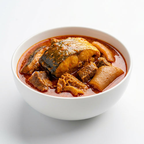 A white ceramic bowl filled with a rich, reddish-brown curry or stew containing fish, chunks of meat, and vegetables, set against a clean white background.