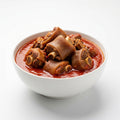 A white ceramic bowl filled with braised pork trotters in a rich red tomato-based sauce, set against a clean white background.